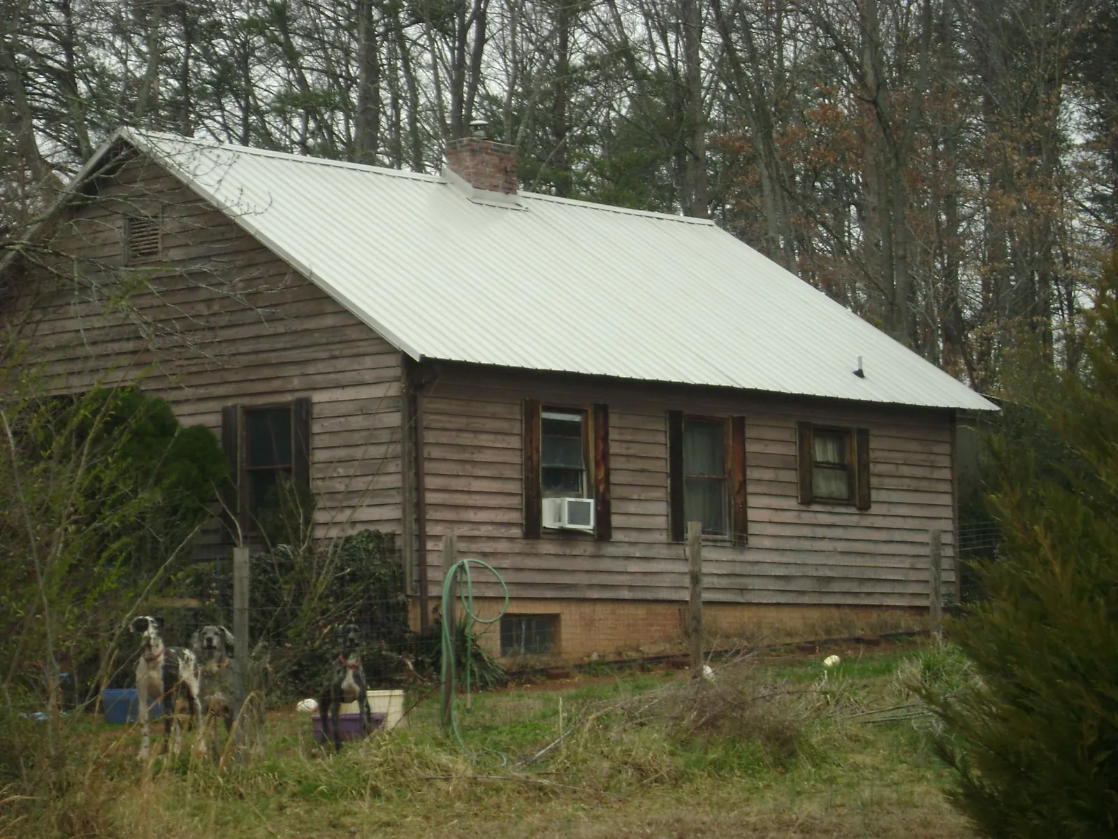 White metal roof on an old wood sided farmhouse, from a Metal Roof Installation job in Newton Grove